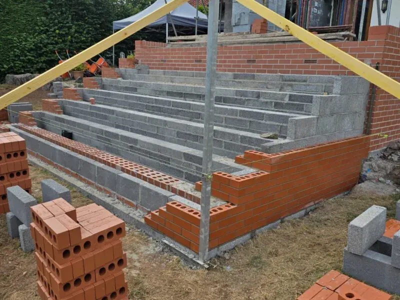 Brick garden steps under construction with a timber prop