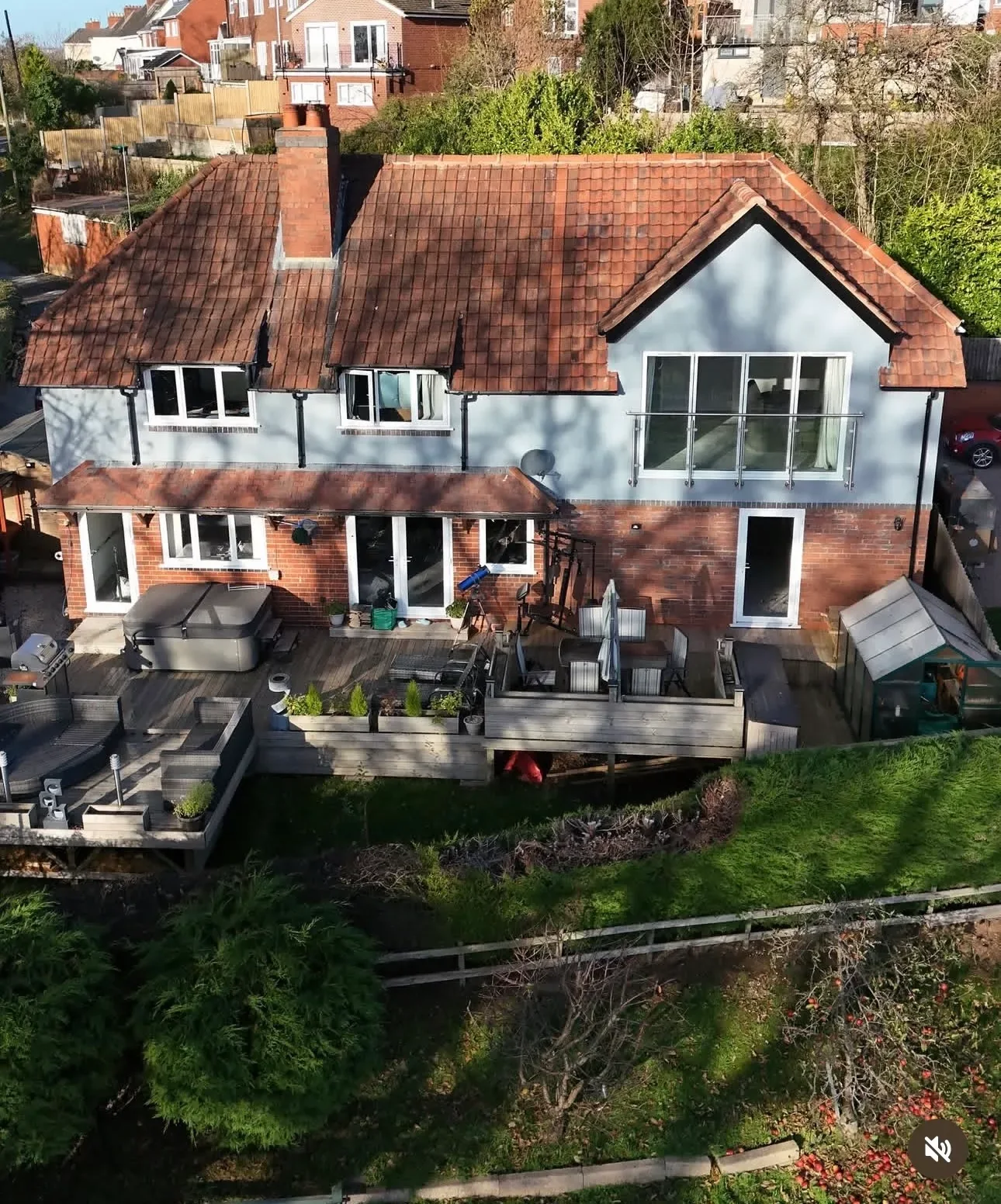 The finished house from the air, with the extension, glazed balcony doors and the decked garden below The finished house from the air, with the extension, glazed balcony doors and the decked garden below