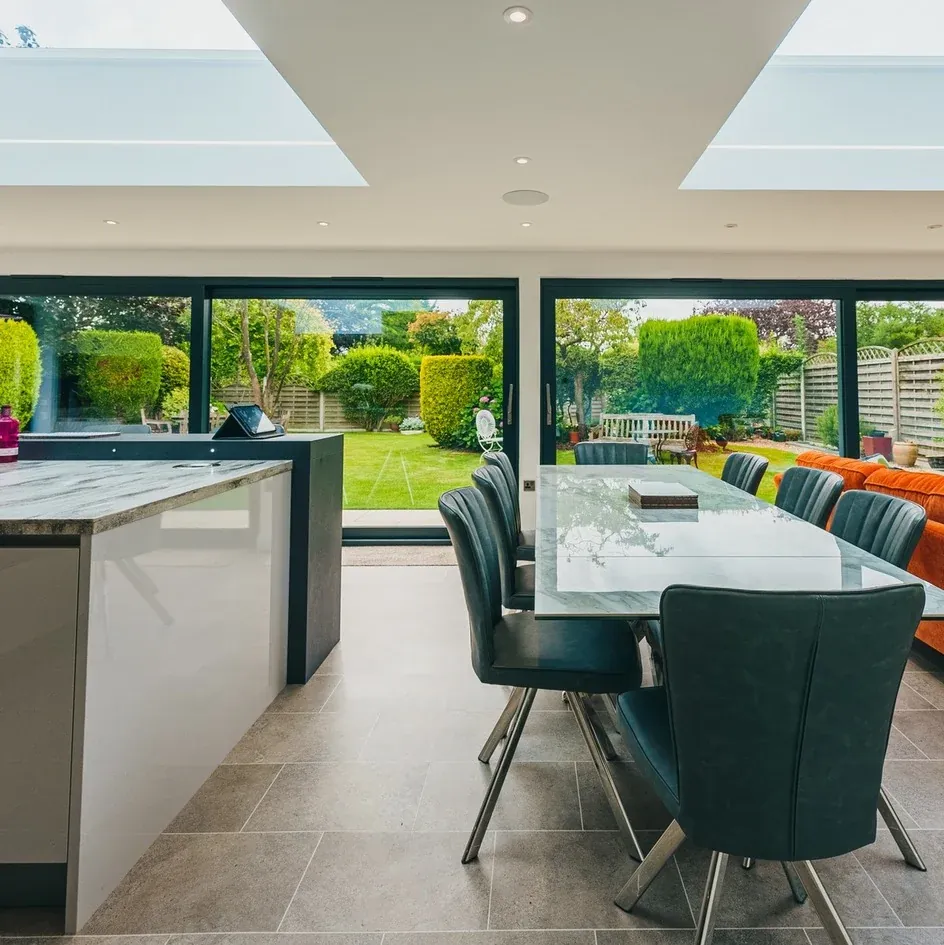 A finished kitchen and dining space with bifold doors and an island A finished kitchen and dining space with bifold doors and an island