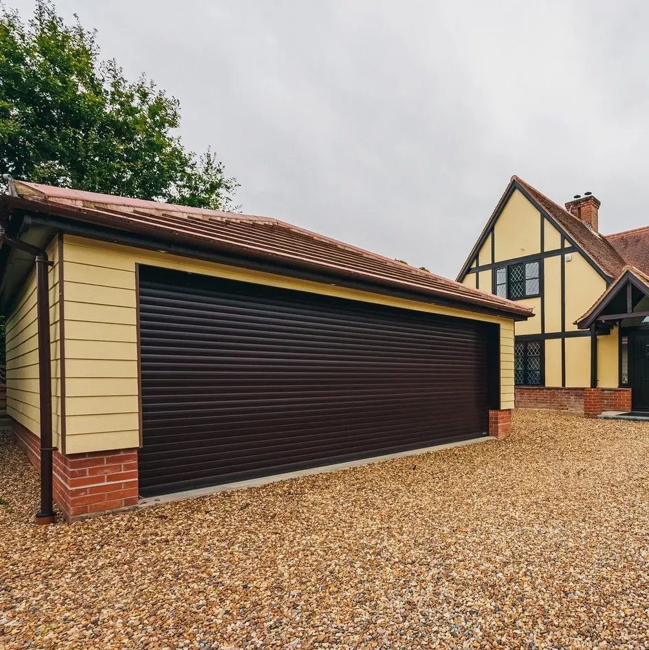 A garage with a brown roller door under a mock-Tudor gable A garage with a brown roller door under a mock-Tudor gable