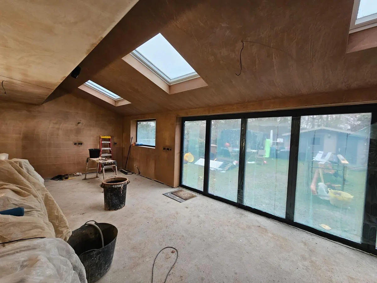 The extension at plaster stage with rooflights in and sliding doors installed