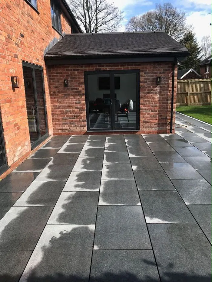 The finished patio with French doors into the single-storey element