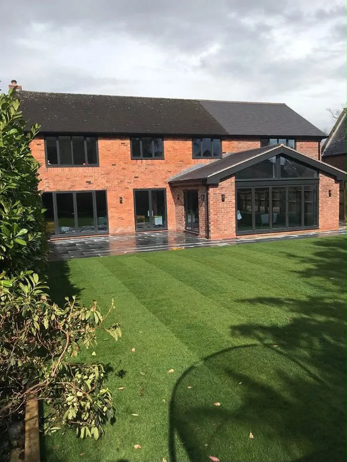 The finished rear elevation seen from the far side of the garden