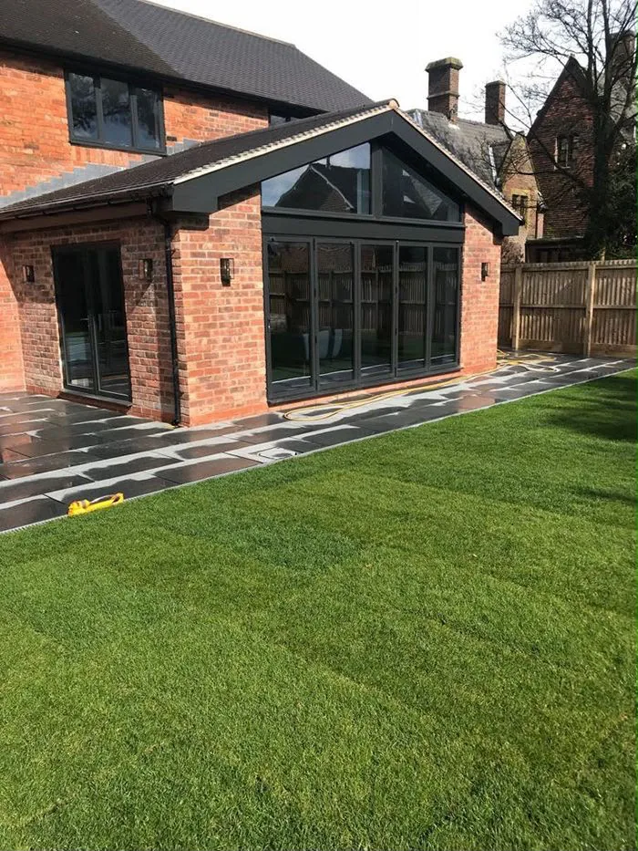 The finished rear of the house seen across the new paving and lawn