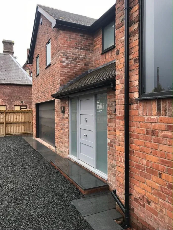 The finished side entrance with a new door and paving